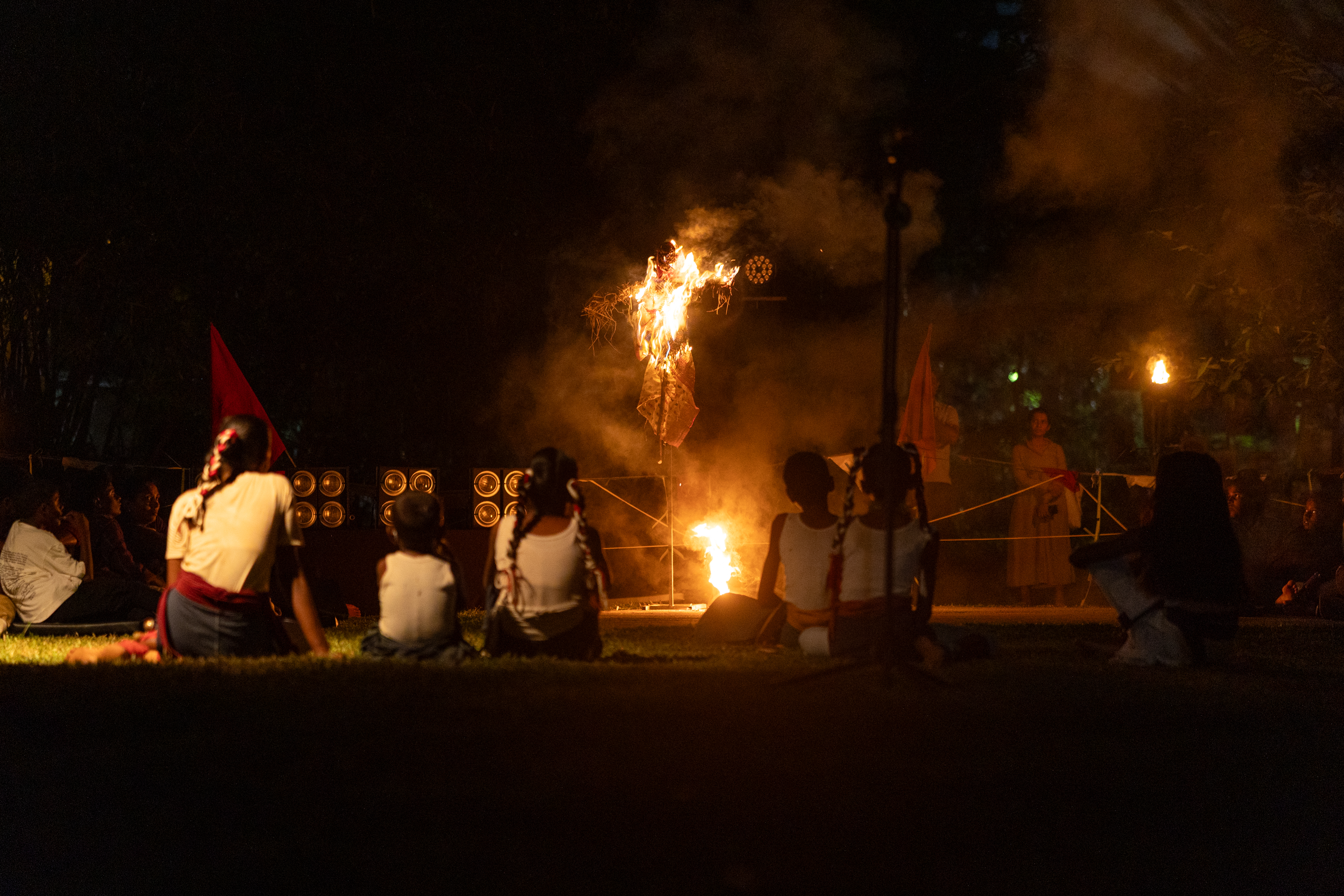Children gathered around a ritual fire during the performance